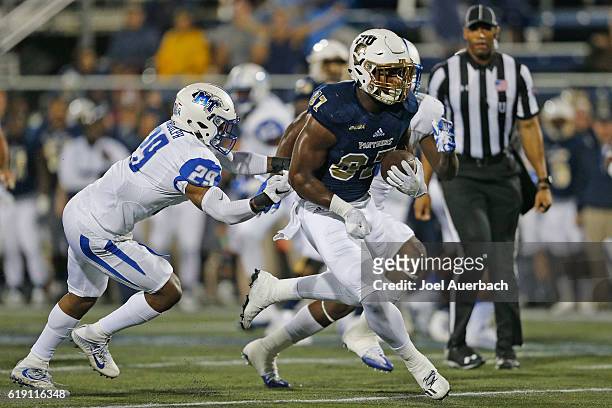 Jonnu Smith of the Florida International Golden Panthers runs for a touchdown past the attempted tackle by Darryl Randolph of the Middle Tennessee...