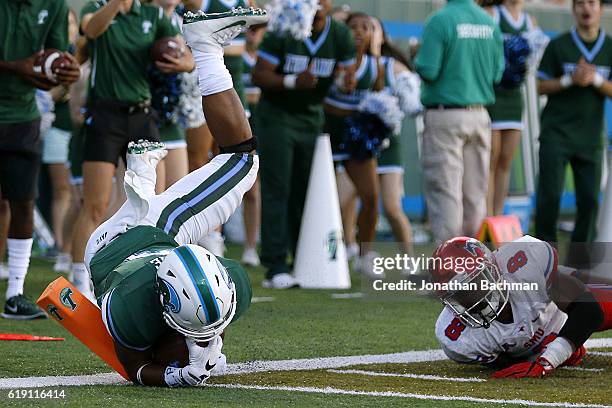 Sherman Badie of the Tulane Green Wave scores a touchdown past Rodney Clemons of the Southern Methodist Mustangs during the second half of a game at...