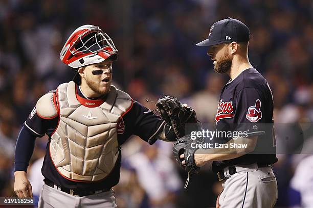Roberto Perez of the Cleveland Indians congratulates Corey Kluber at the end of the first inning against the Chicago Cubs in Game Four of the 2016...