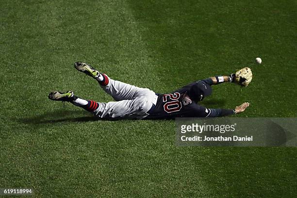 Rajai Davis of the Cleveland Indians dives and fails to make a catch in the first inning against the Chicago Cubs in Game Four of the 2016 World...