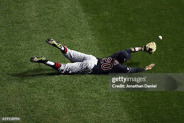 Rajai Davis of the Cleveland Indians dives and fails to make a catch in the first inning against the Chicago Cubs in Game Four of the 2016 World...