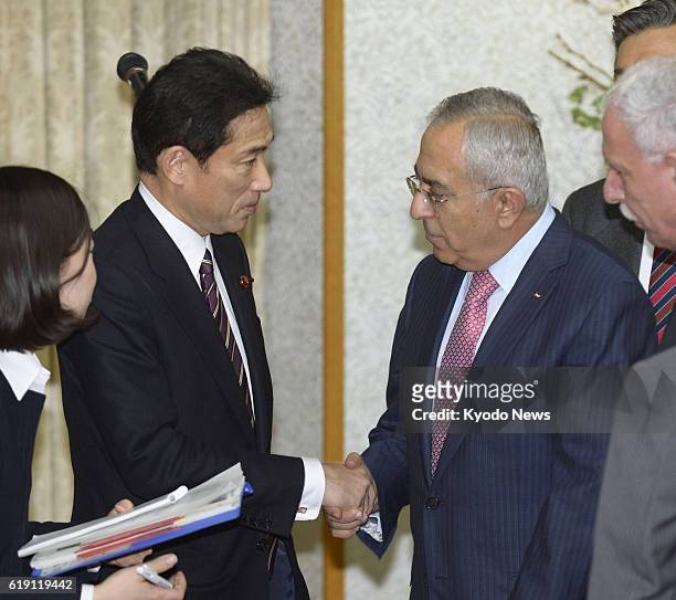 Japan - Japanese Foreign Minister Fumio Kishida and Palestinian Prime Minister Salam Fayyad shake hands at a meeting in Tokyo on Feb. 13, 2013. Japan...