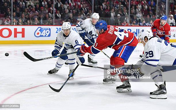 Paul Byron of the Montreal Canadiens takes a shot against Connor Carrick and William Nylander of the Toronto Maple Leafs in the NHL game at the Bell...