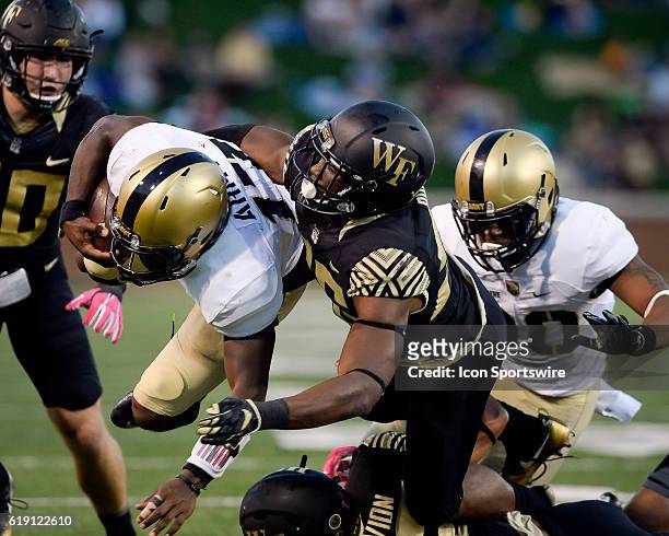 Army quarterback Ahmad Bradshaw gets tackled by Wake Forest's Thomas Brown during the Army Black Knight's 21-13 win over the Wake Forest Demon...