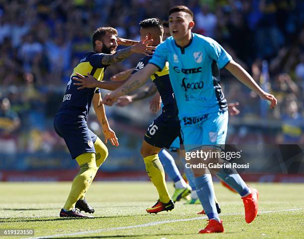 Gino Peruzzi of Boca Juniors and celebrates with teammate Adrian Centurion after scoring the first goal of his team during a match between Boca...