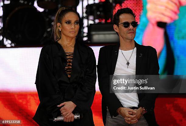 Singers Jennifer Lopez and Marc Anthony look on as Democratic presidential nominee former Secretary of State Hillary Clinton speaks during a Get Out...