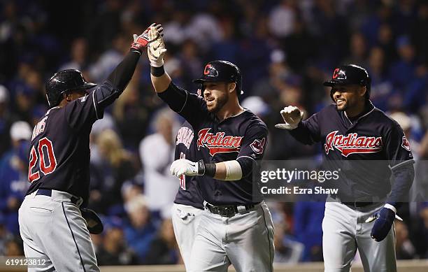 Rajai Davis and Coco Crisp of the Cleveland Indians congratulate Jason Kipnis after Kipnis hit a home run in the seventh inning against the Chicago...