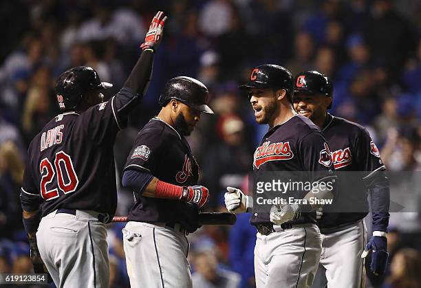Rajai Davis, Carlos Santana, and Coco Crisp of the Cleveland Indians congratulate Jason Kipnis after Kipnis hit a home run in the seventh inning...