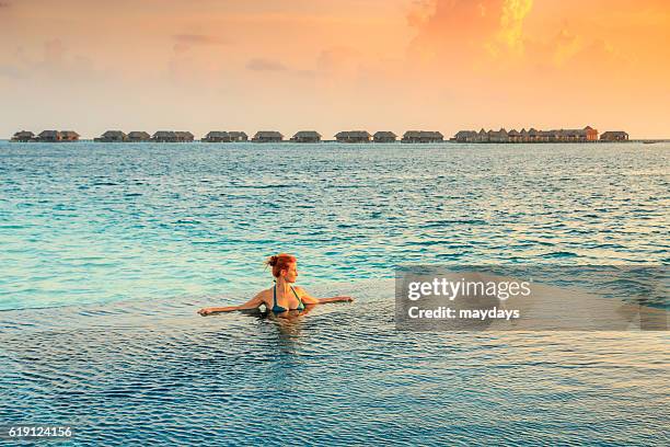 woman in the infinity pool in maldives - ari stock pictures, royalty-free photos & images