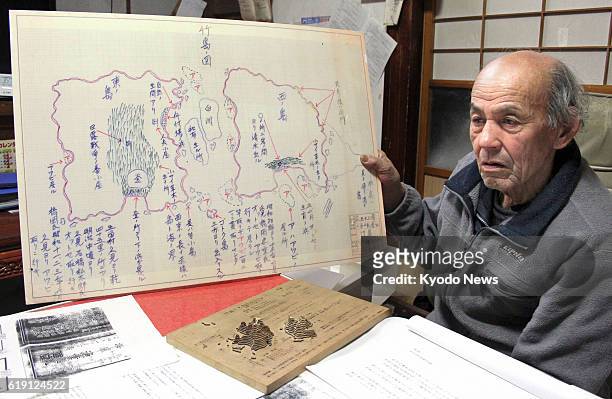 Okinoshima, Japan - Shoza Yawata shows materials he has collected regarding the ownership of a group of islets in the Sea of Japan, called Takeshima...
