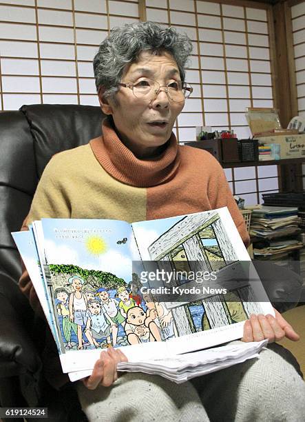 Okinoshima, Japan - Yumiko Sugihara holds a picture book she has completed in the town of Okinoshima, Shimane Prefecture, on Jan. 22, 2013. The book...