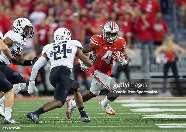 Ohio State Buckeyes running back Curtis Samuel attempts to get around Northwestern Wildcats safety Kyle Queiro during an NCAA football game between...