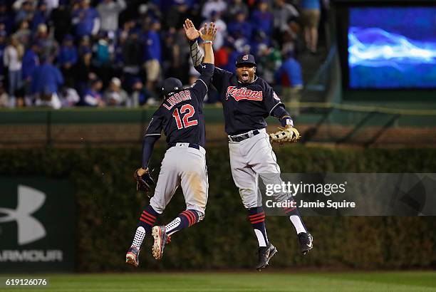 Francisco Lindor and Rajai Davis of the Cleveland Indians celebrate after beating the Chicago Cubs 7-2 in Game Four of the 2016 World Series at...