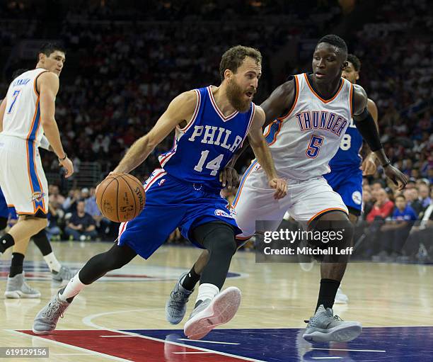 Sergio Rodriguez of the Philadelphia 76ers drives to the basket against Victor Oladipo of the Oklahoma City Thunder at Wells Fargo Center on October...