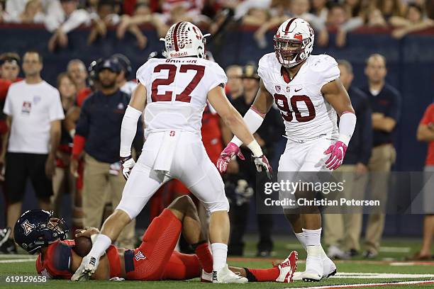 Defensive end Solomon Thomas of the Stanford Cardinal celebrates with linebacker Sean Barton after a sack on quarterback Brandon Dawkins of the...