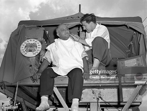 Charlie Lupica Cleveland pole-sitter, entertained his first visitor when his barber, Chuck DiMarco climbed aboard his four by four foot platform to...