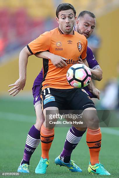Thomas Oar of the Roar and Marc Warren of the Glory compete for the ball during the round four A-League match between the Brisbane Roar and Perth...