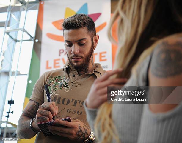 Italian rapper Emis Killa meeting fans and signing copies of his last album 'Terza Stagione' on October 29, 2016 in Livorno, Italy.
