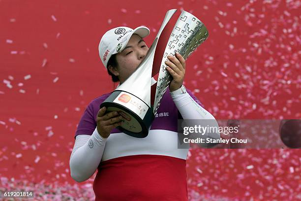 Shanshan Feng of China kisses the Sime Darby LPGA trophy after she won it 17 under par 267 during day four of the Sime Darby LPGA at TPC Kuala Lumpur...