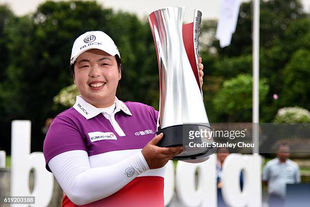 Shanshan Feng of China poses with the Sime Darby LPGA trophy after she won it 17 under par 267 during day four of the Sime Darby LPGA at TPC Kuala...