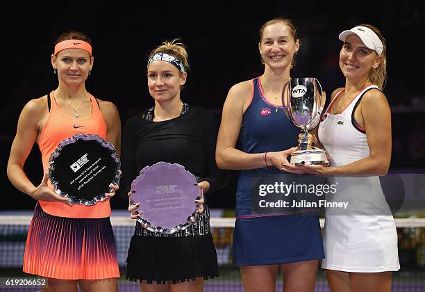 Champions Ekaterina Makarova and Elena Vesnina of Russia pose with Bethanie Mattek-Sands of the United States and Lucie Safarova of Czech Republic...