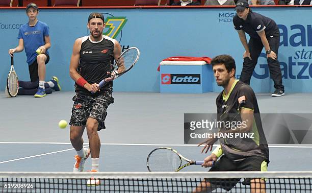 Poland's Lukasz Kubot and Brazilian Marcelo Melo return a ball during the doubles final match against Austria's Oliver Marach and France's Fabrice...