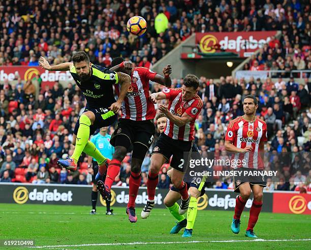 Arsenal's French striker Olivier Giroud heads the ball to score their third goal during the English Premier League football match between Sunderland...