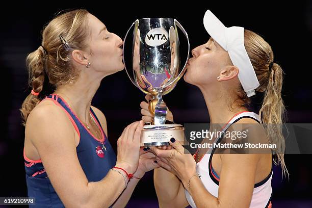 Ekaterina Makarova and Elena Vesnina of Russia kiss the trophy after victory in the doubles final match against Bethanie Mattek-Sands of the United...