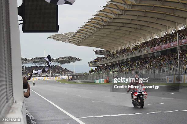 Andrea Dovizioso of Italy and Ducati Team cuts the finish lane and celebrates the victory at the end of the MotoGP race during the MotoGP Of Malaysia...