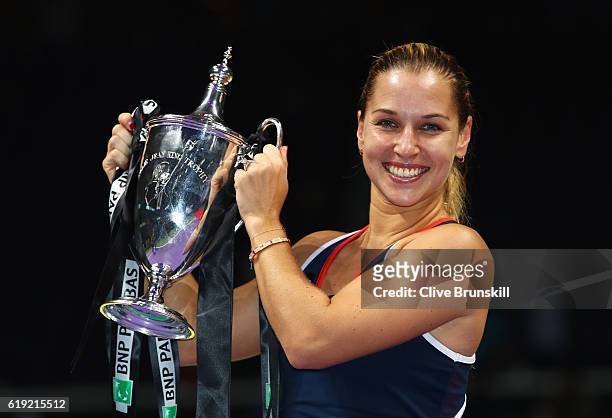 Dominika Cibulkova of Slovakia poses with the trophy after victory in her singles final against Angelique Kerber of Germany during day 8 of the BNP...
