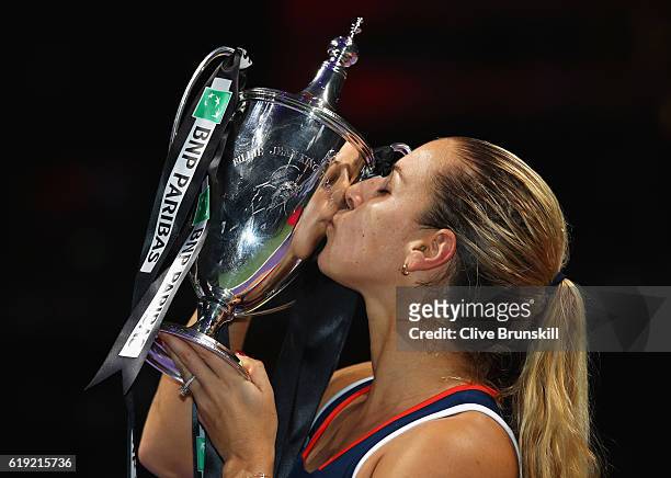 Dominika Cibulkova of Slovakia kisses the trophy after victory in her singles final against Angelique Kerber of Germany during day 8 of the BNP...