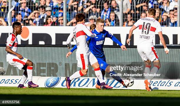 Florian Kamberi of Karlsruhe challenges Takuma Asano of Stuttgart and Kevin Grosskreutz of Stuttgart during the Second Bundesliga match between...