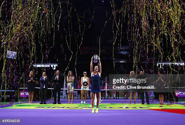 Dominika Cibulkova of Slovakia lifts the trophy after victory in her singles final against Angelique Kerber of Germany during day 8 of the BNP...