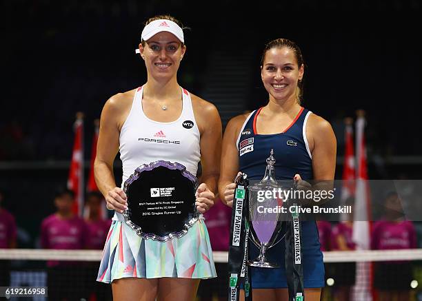 Runner up Angelique Kerber of Germany and Champion Dominika Cibulkova of Slovakia pose with their trophies after the singles final during day 8 of...