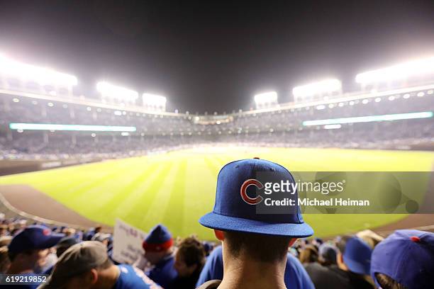 Fan wearing a Cubs hat watches from the bleachers during Game Three of the 2016 World Series between the Chicago Cubs and the Cleveland Indians on...