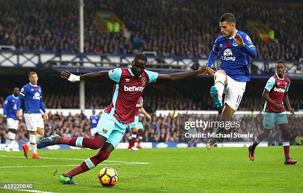 Cheikhou Kouyate of West Ham United attempts to pass the ball while Kevin Mirallas of Everton puts him under pressure during the Premier League match...