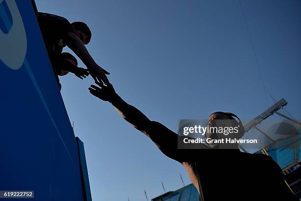 Robert McClain of the Carolina Panthers high-fives a fan during the game against the Arizona Cardinals at Bank of America Stadium on October 30, 2016...