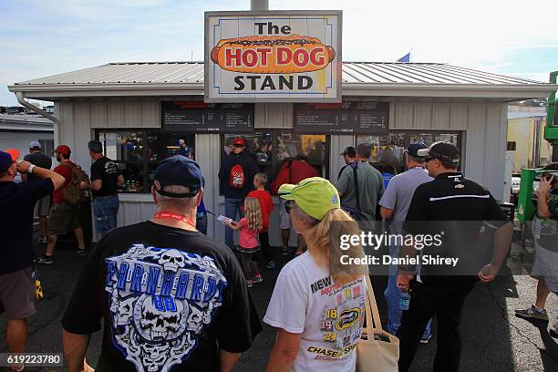 Fans gather around the Hot Dog stand for sliders prior to the NASCAR Sprint Cup Series Goody's Fast Relief 500 at Martinsville Speedway on October...