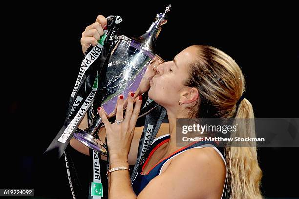 Dominika Cibulkova of Slovakia kisses the trophy after victory in her singles final against Angelique Kerber of Germany during day 8 of the BNP...