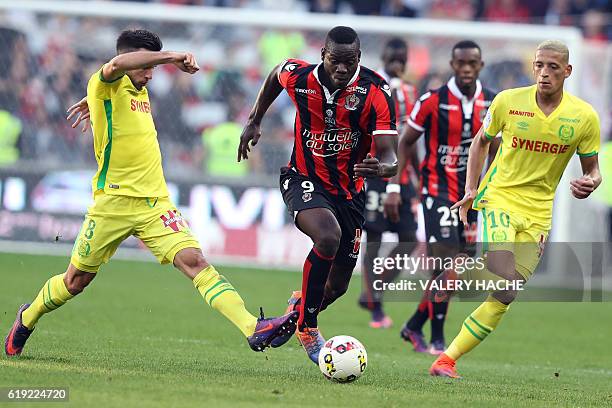 Nice's Italian forward Mario Balotelli vies with Nantes' French midfielder Adrien Thomasson during the French L1 football match Nice vs Nantes on...