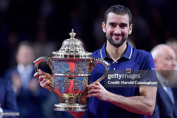 Marin Cilic of Croatia holds the trophy as he celebrates his victory during the Swiss Indoors ATP 500 tennis tournament final match against Kei...