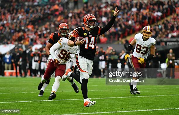 Andy Dalton of the Cincinnati Bengals celebrates as he runs in for a touchdown during the NFL International Series Game between Washington Redskins...