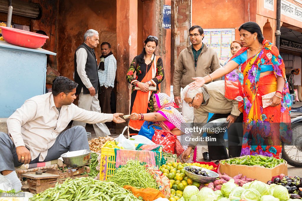 Customers buying vegetables on the street, Udaipur, Rajasthan, India