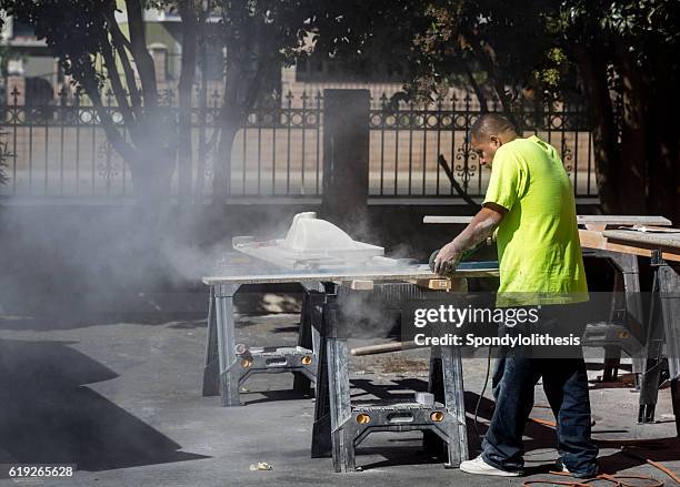 mexican worker cutting granite without any protection - respiratory protection construction stock pictures, royalty-free photos & images
