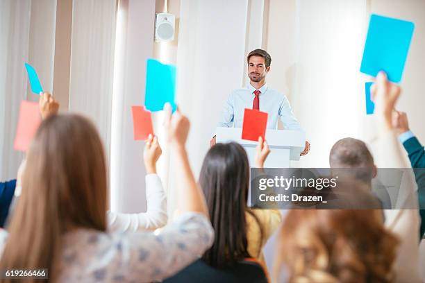 voting for candidates on meeting - collaboration government stock pictures, royalty-free photos & images