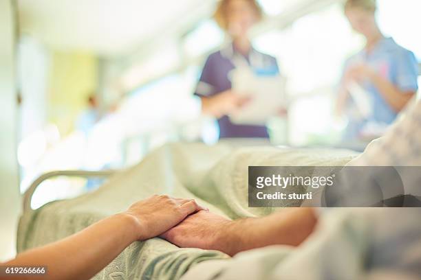 hospital visiting - old bed stockfoto's en -beelden