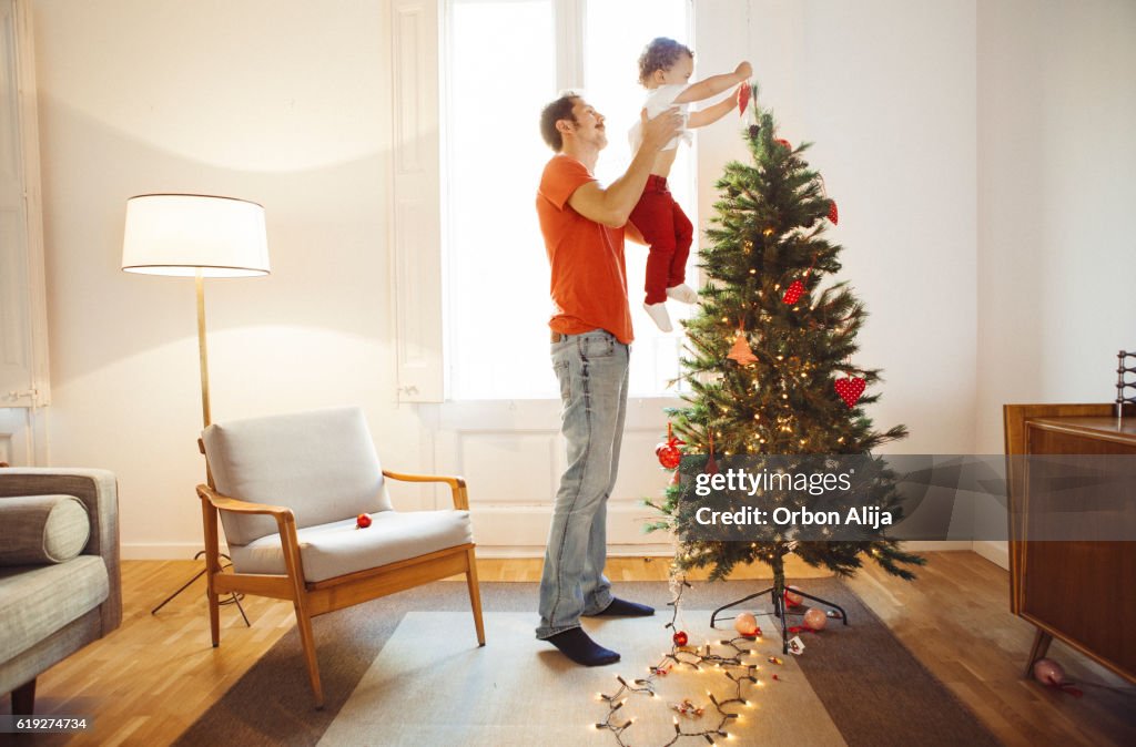 Father and son decorating the Christmas tree