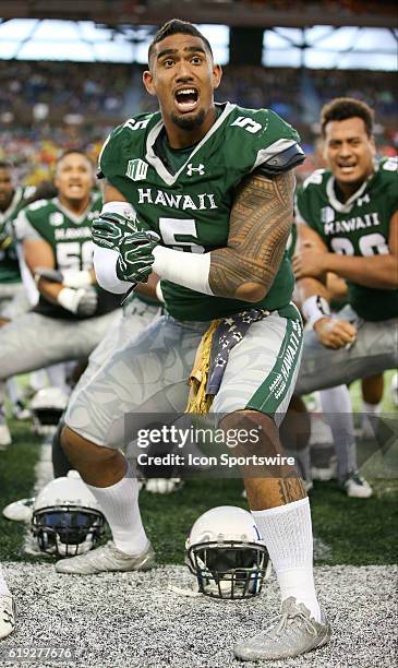 Hawai'I Rainbow Warriors defensive lineman Makani Kema-Kaleiwahea does the Haa while wearing a 50+ year old U.S. Flag given to him by a Vietnam...