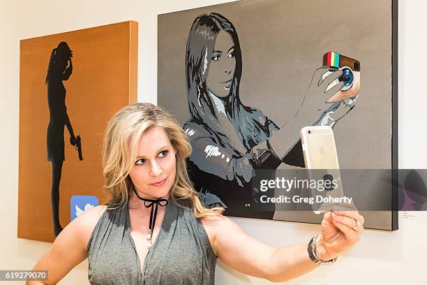 Actress Abi Titmuss takes a selfie at the Gallery Opening Of "Social Distortion: A Capsule Collection Of Fine Art By Billy Morrison" at Art On Scene...