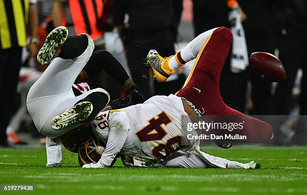 Niles Paul of the Washington Redskins collides with Rey Maualuga of the Cincinnati Bengals during the NFL International Series Game between...